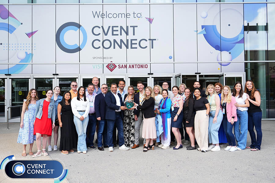 Group of professionals in front of CVENT signage