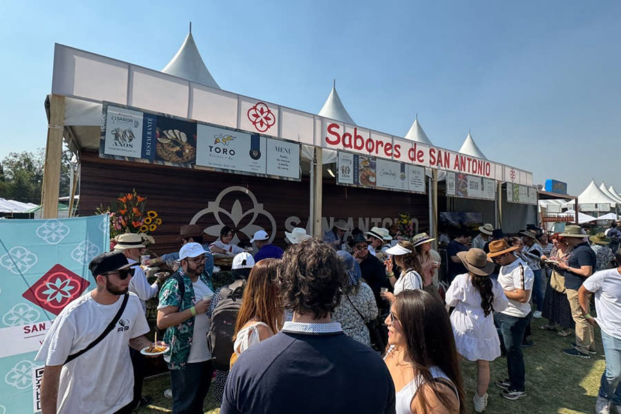 People gathered under tented awning
