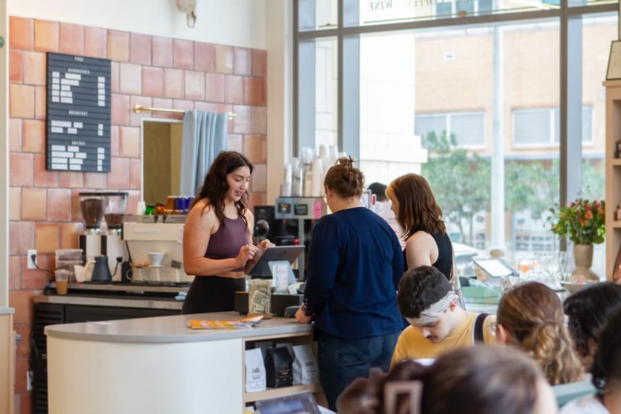 people at register at a coffee shop