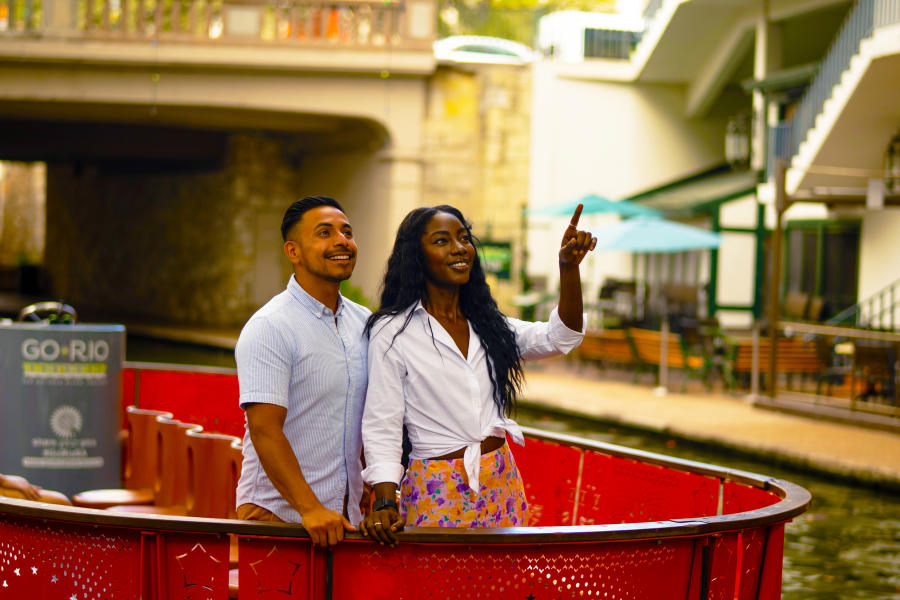 Couple on a Go Rio Barge on the River Walk smiling