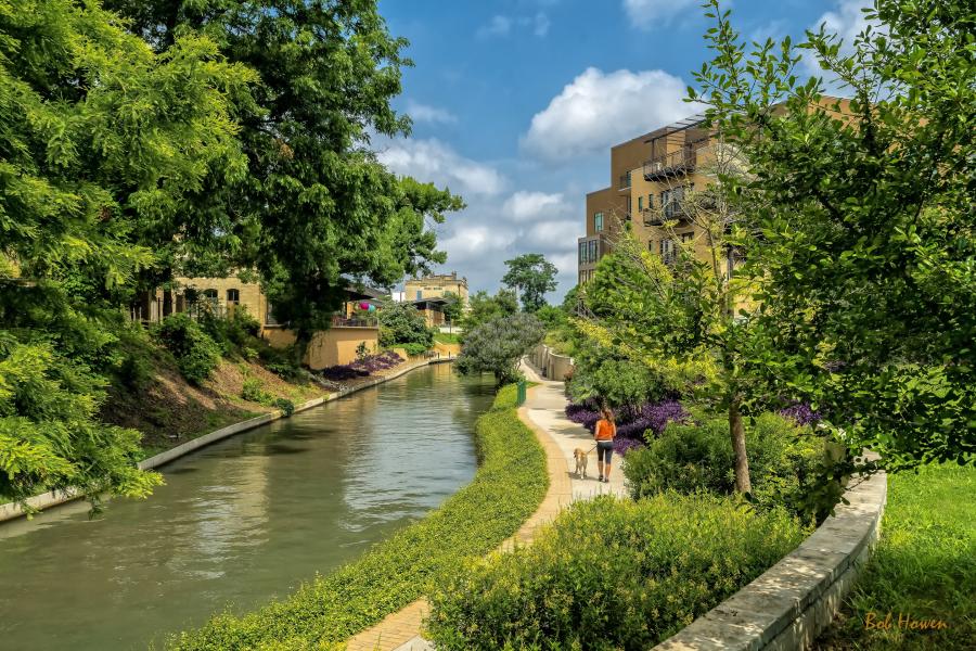 Woman walking dog along Museum Reach of River Walk