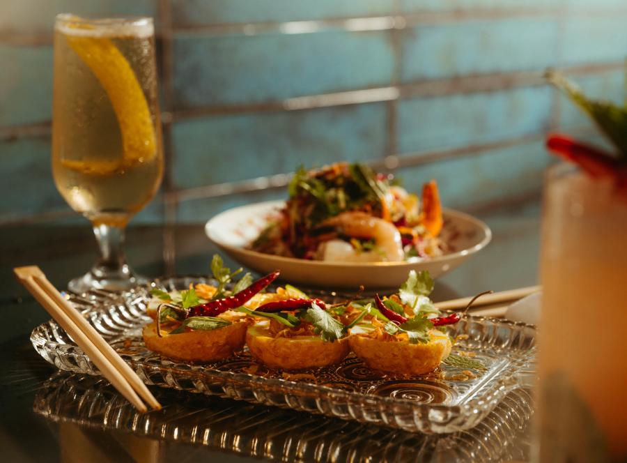Tokyo Cowboy dinner spread with tall beverage glass.