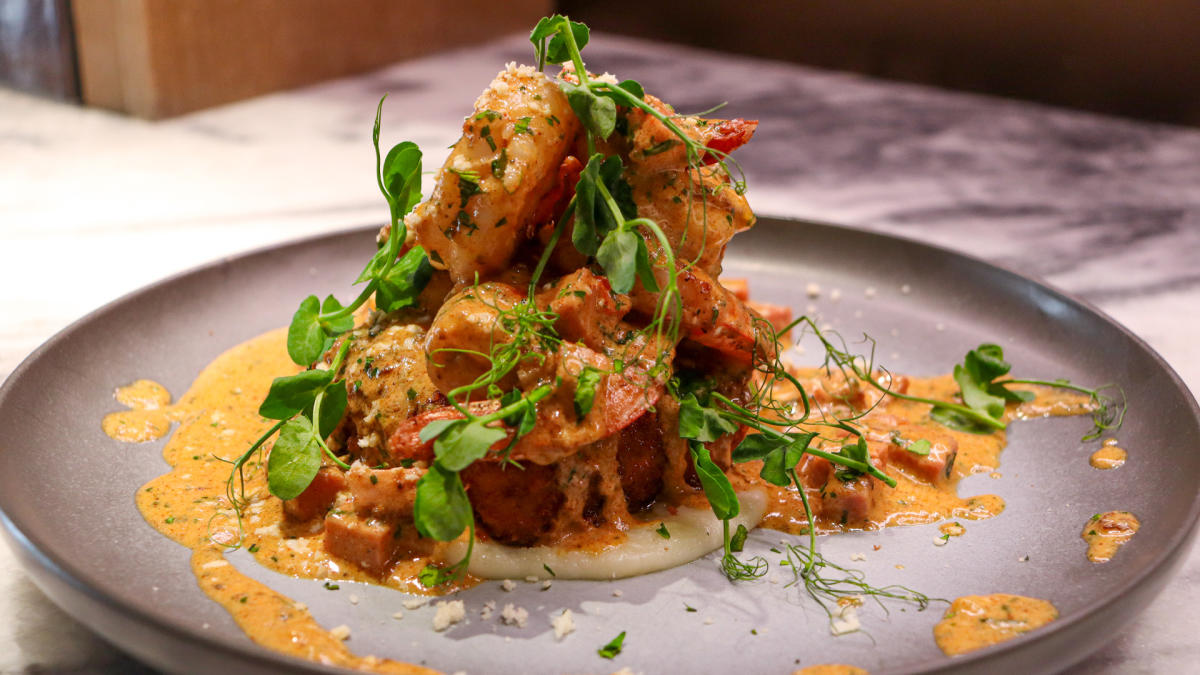 Plated dish with creamy toppings on top of it.