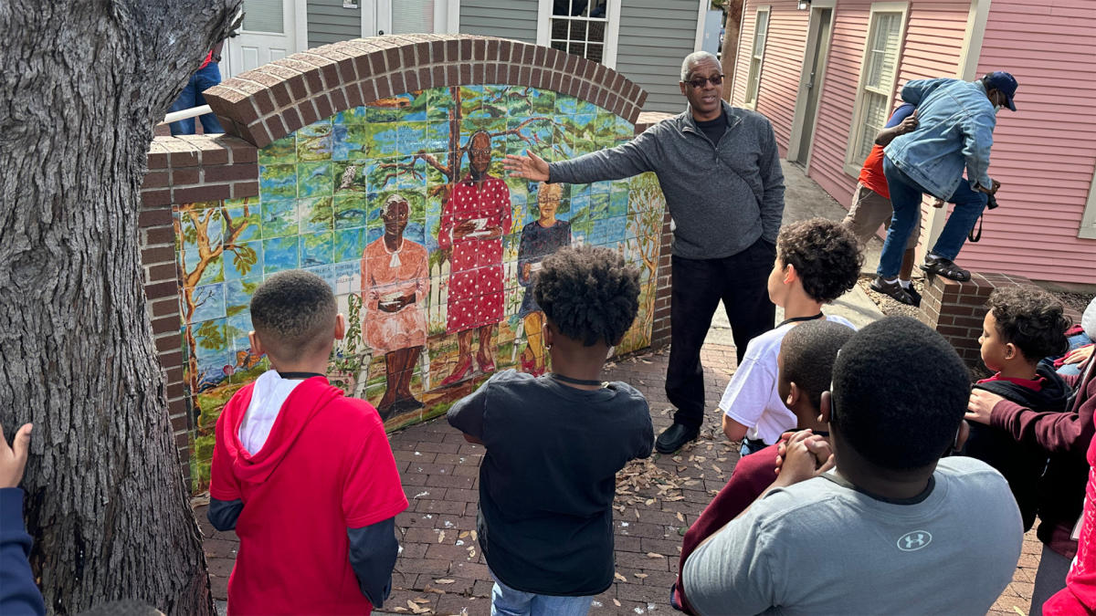Man explaining piece of artwork to group