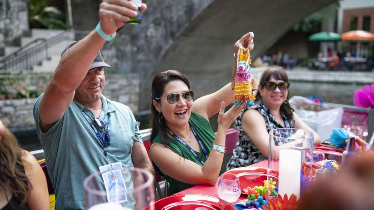 People holding drinks up in a toast