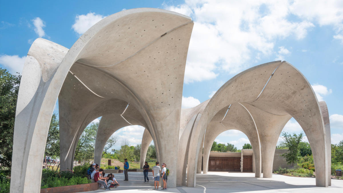 Domes at confluence park with people walking beneath them.
