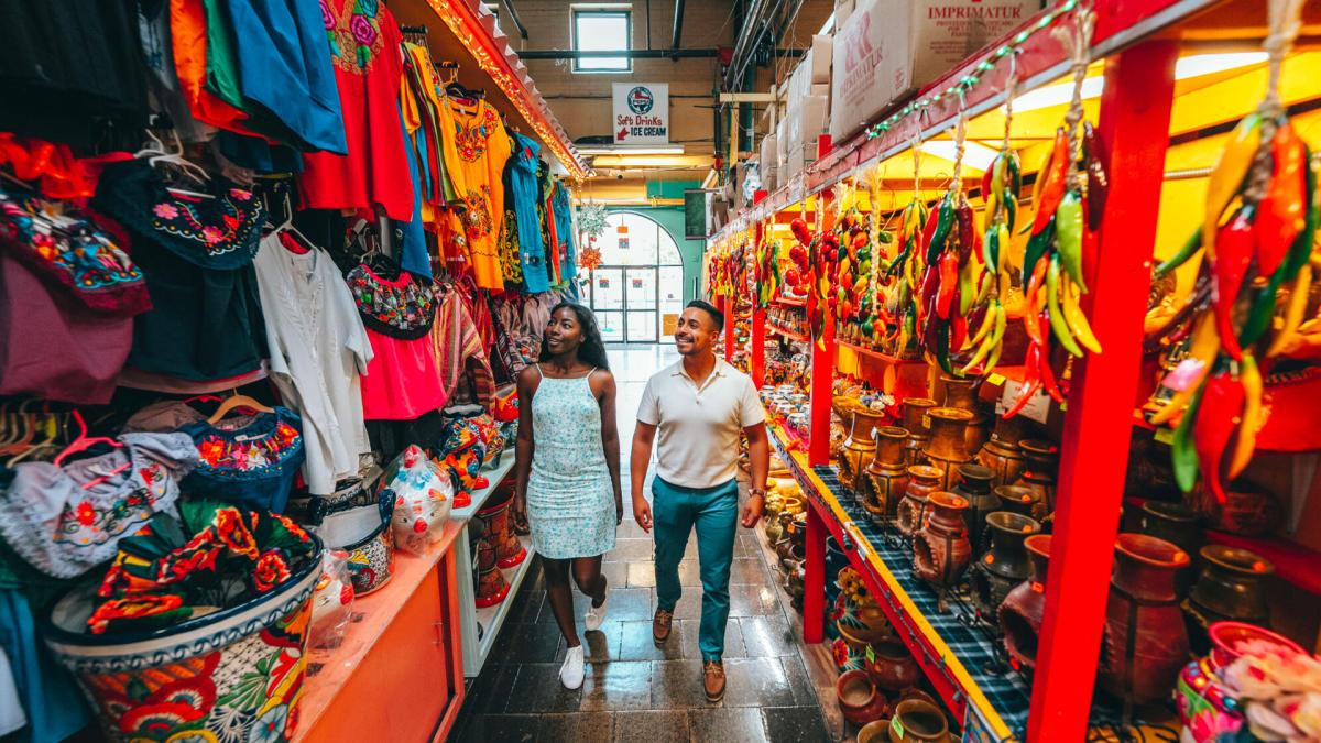 Man and woman walking through aisle at Historic Market Square