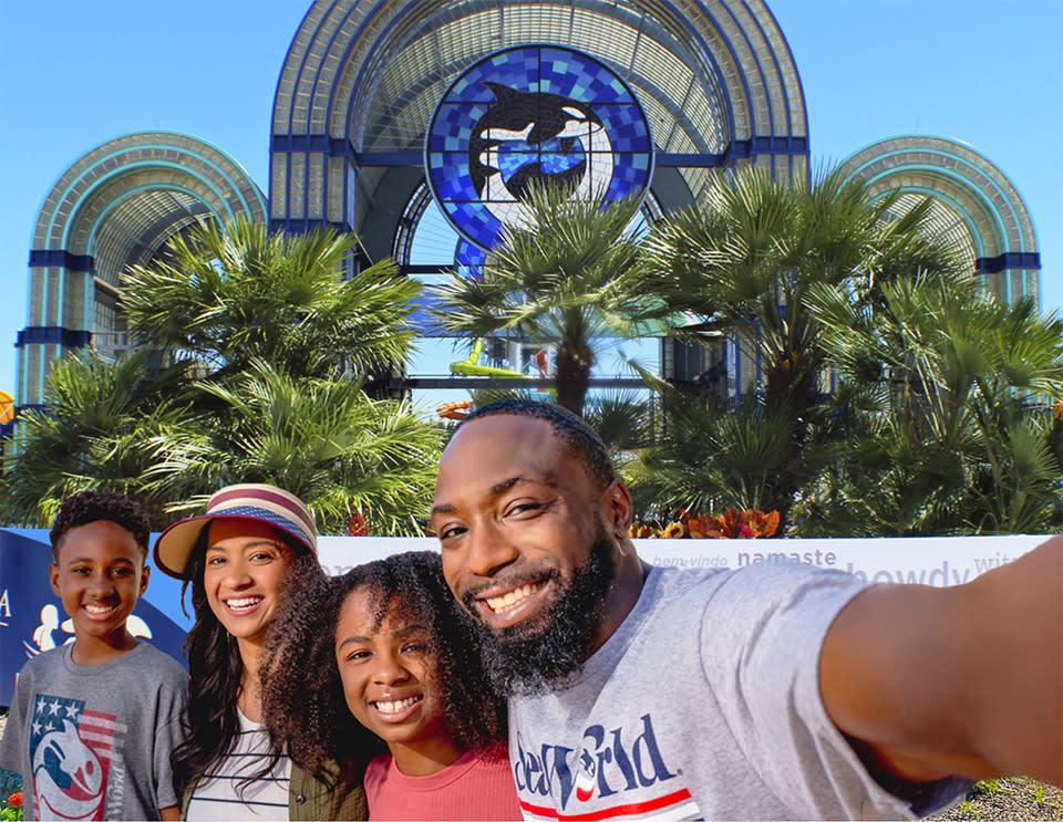Family taking selfie in front of SeaWorld San Antonio arches