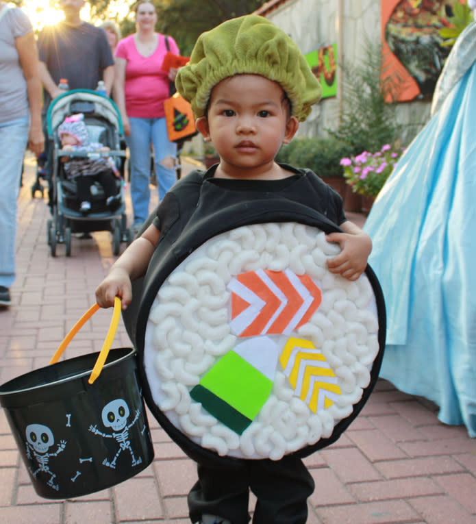 Child dressed up as sushi and holding a Halloween bucket at the San Antonio Zoo