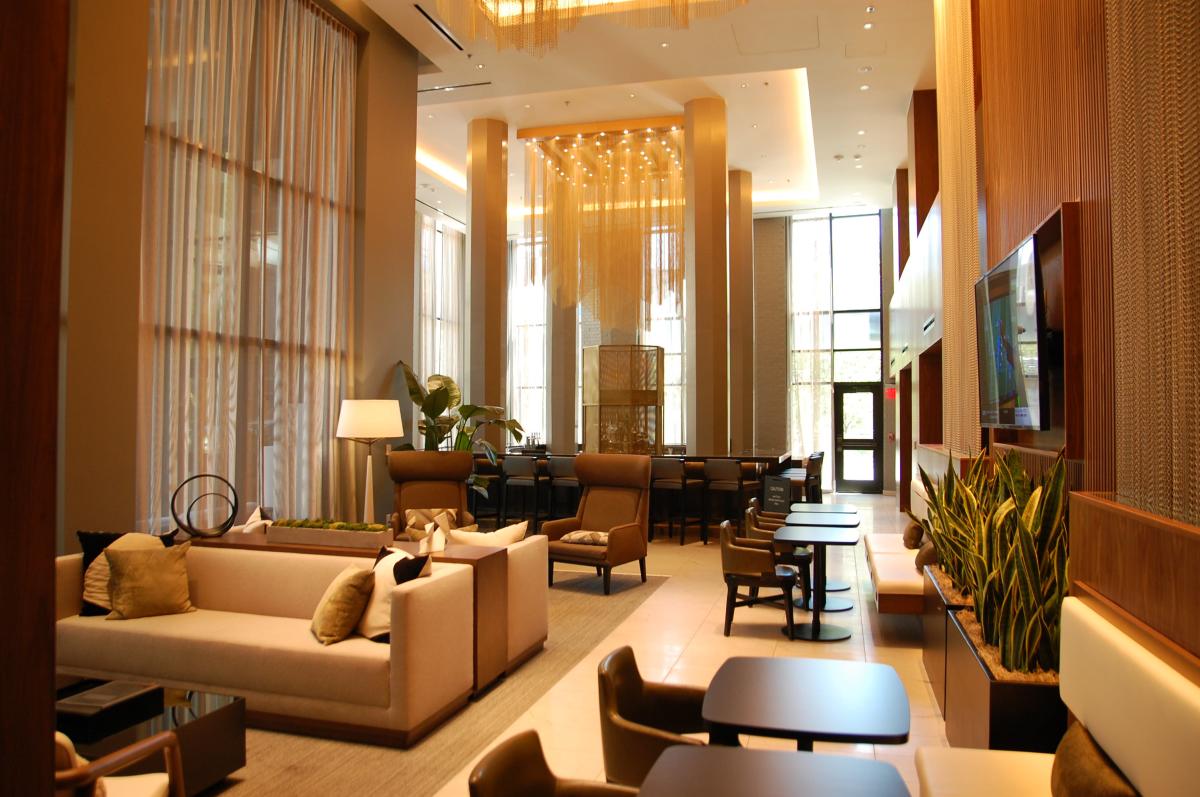 Tables and chairs in lounge area of AC Marriott