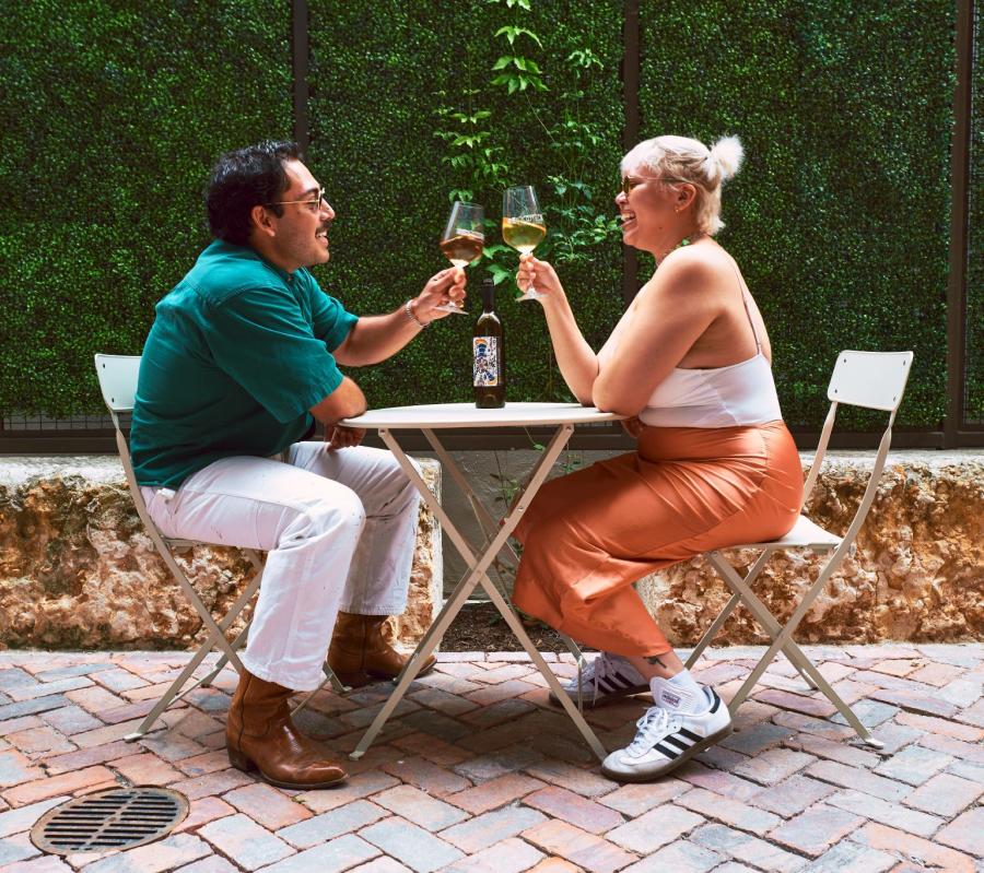 Couple enjoying wine cheersing at Re:Rooted 210