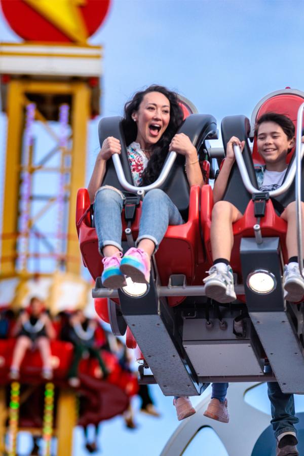 Mother and son laughing on Cyborg ride at Six Flags Fiesta Texas.