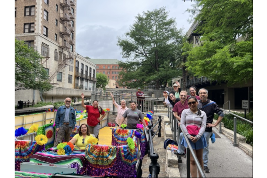 people posing for photo on river walk