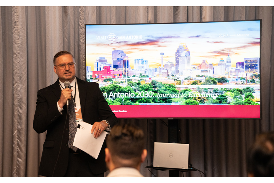 Man speaking in front of presentation