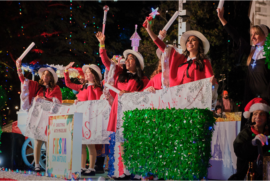 Girls dressed as book character Madeline waving with wands