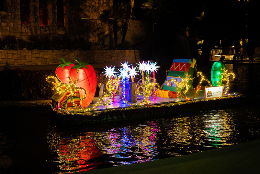 Illuminated chili peppers on river barge