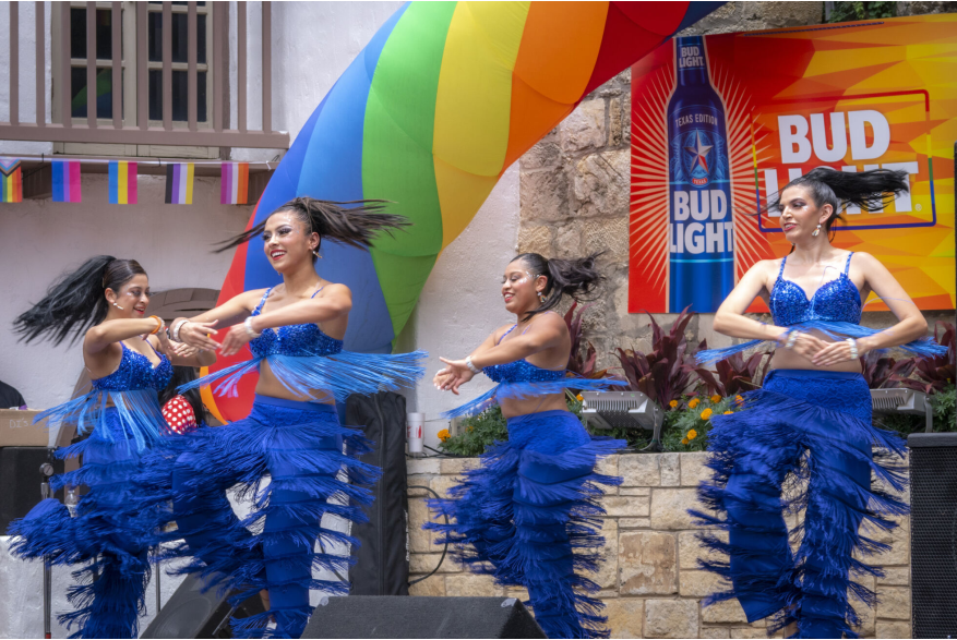 Dancers in blue uniform at Pride River Parade