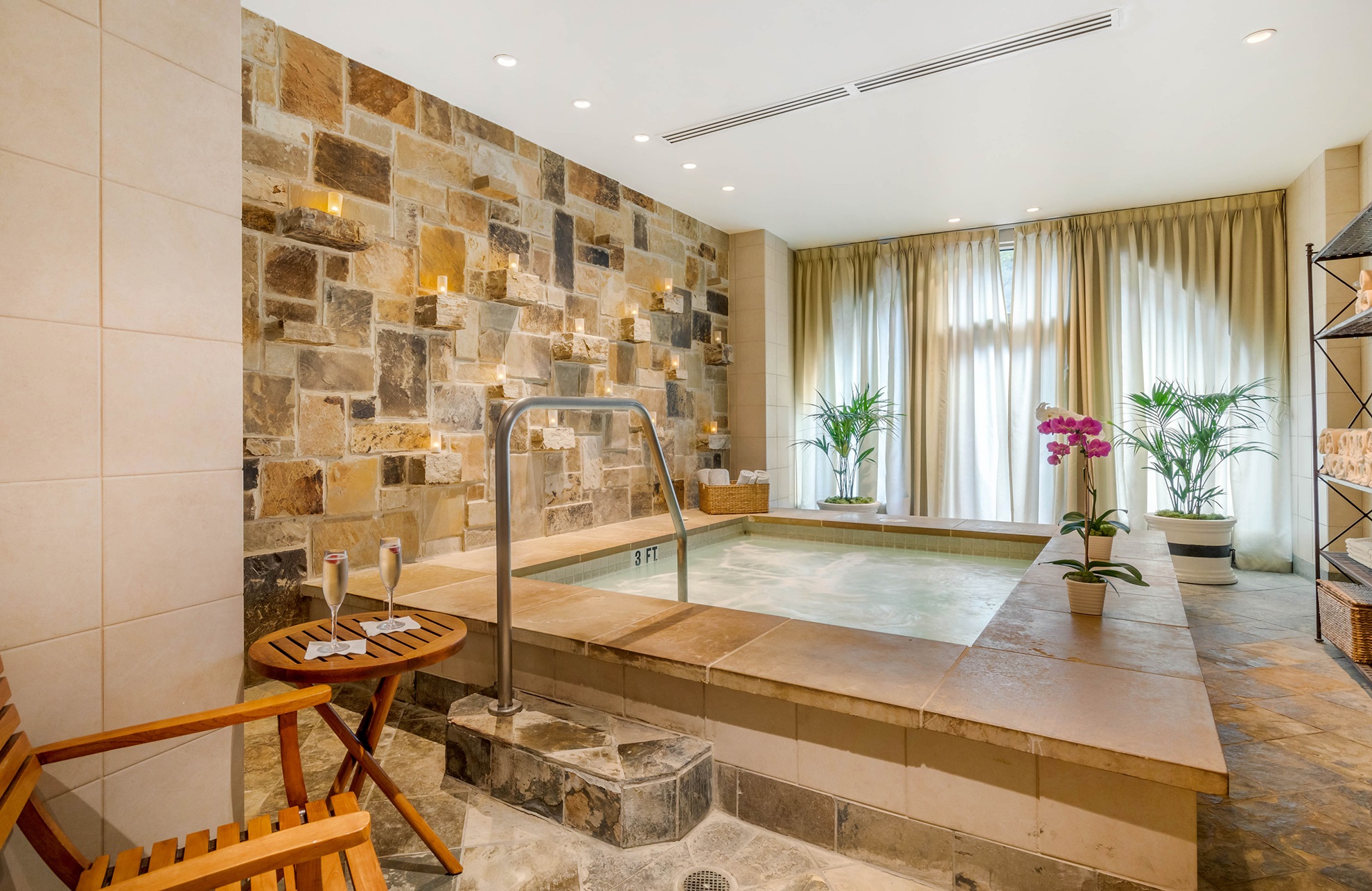 Spa at Mokara Spa in San Antonio with pink orchid on side.