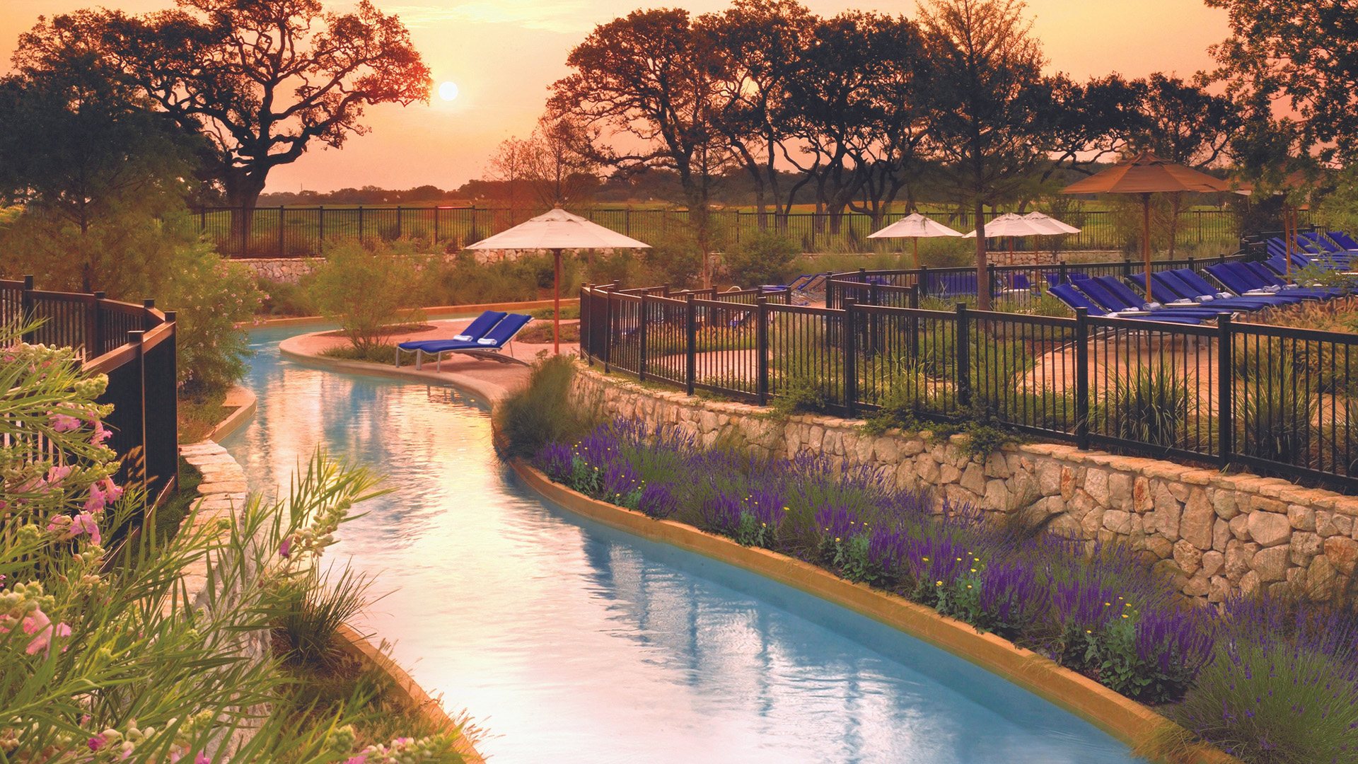 Lazy river with umbrellas at Lantana Spa in San Antonio.
