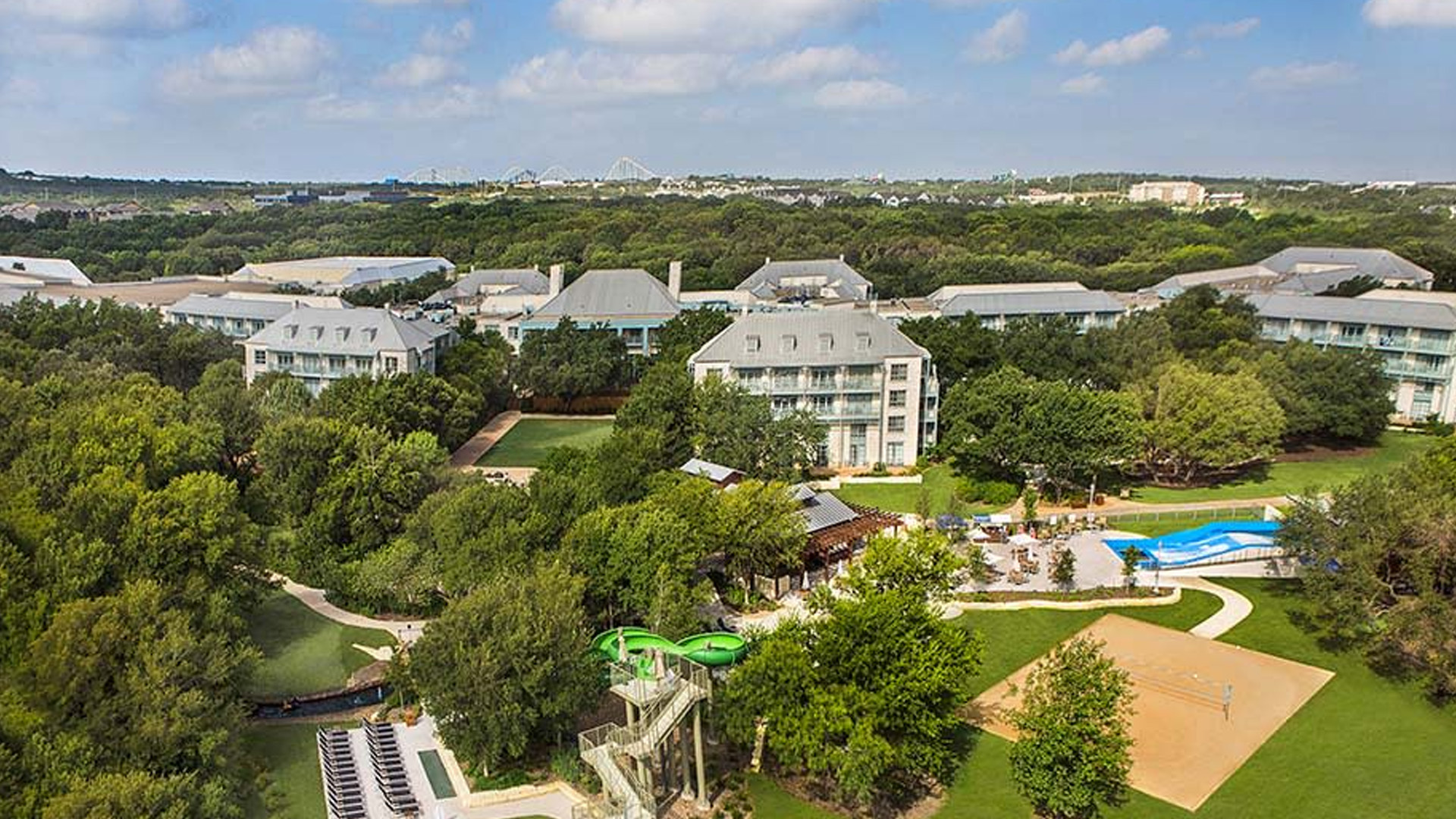 Bird's eye view of Hyatt Regency Hotel in San Antonio including golfing greens, lazy river, and hotel buildings.