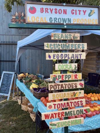 Hand painted sign indicating the types of produce available at a vendor's booth in the Smoky Mountain Farmers and Artisans Market