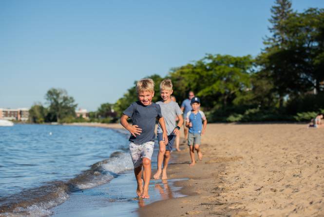 kids running along the beach at clinch park