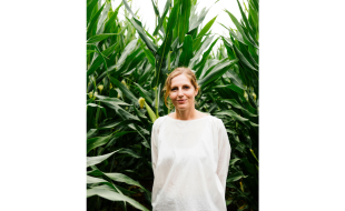 headshot of Abra Berens in front of tall plants