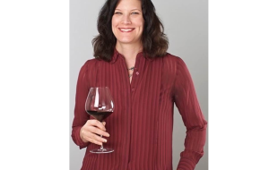 Headshot of Susan Kostrzewa holding a wine glass