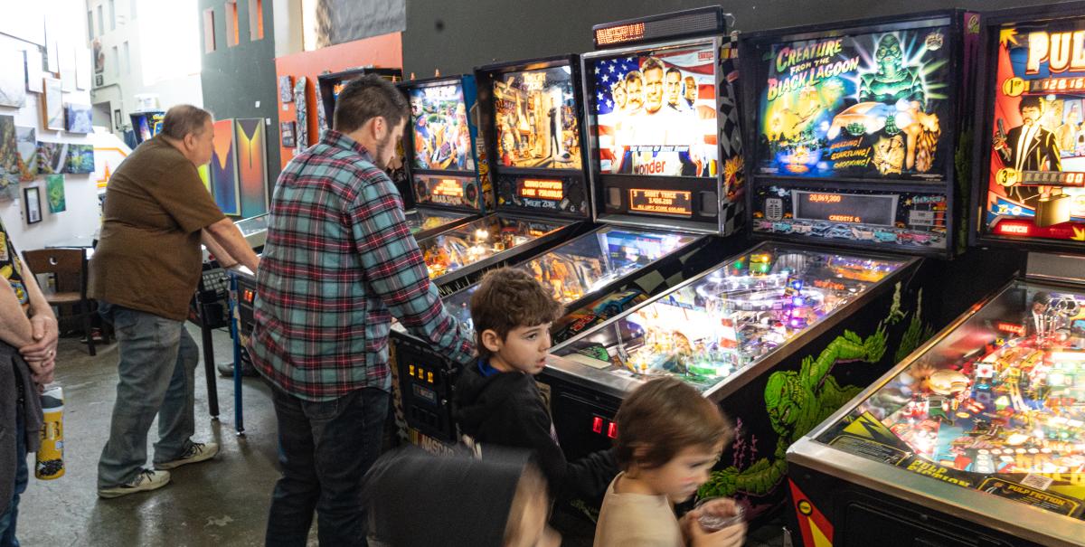People playing pinball at Right Brain Brewery
