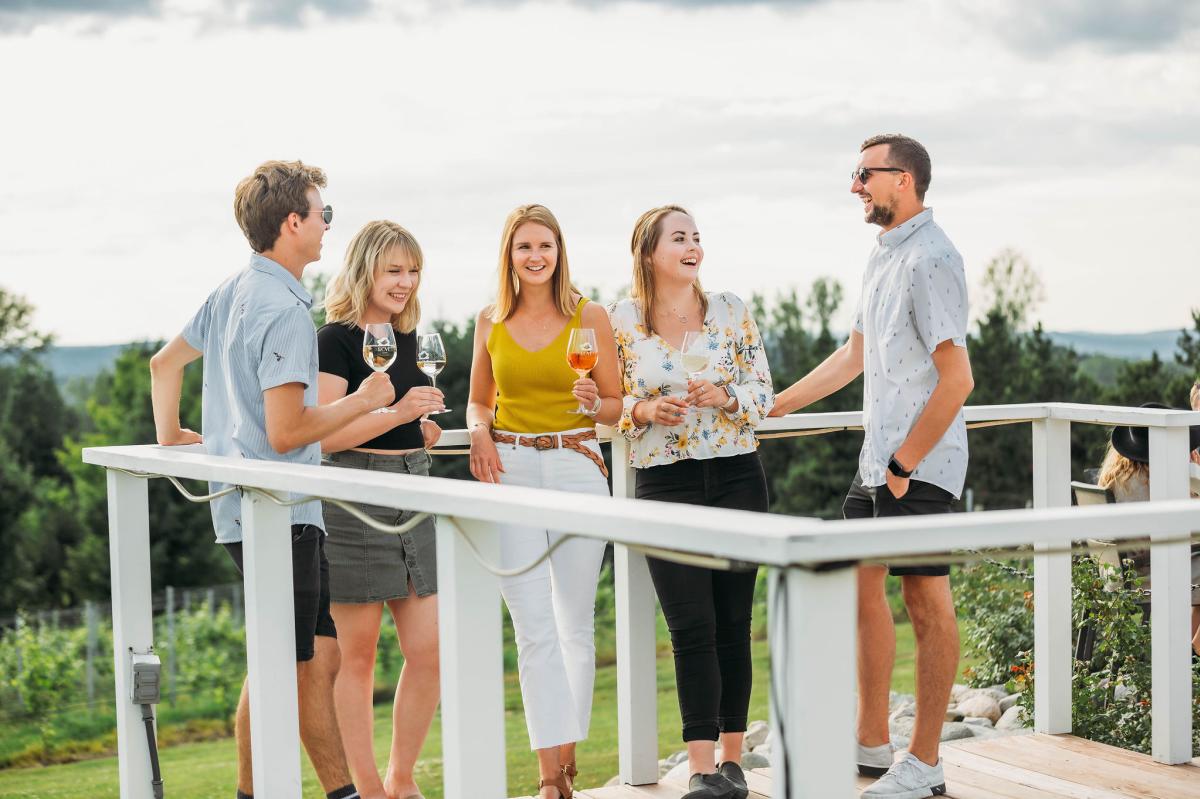 five friends enjoying wine on the patio at Rove Winery at Gallagher Estate on the Leelanau Peninsula in Traverse City, Michigan