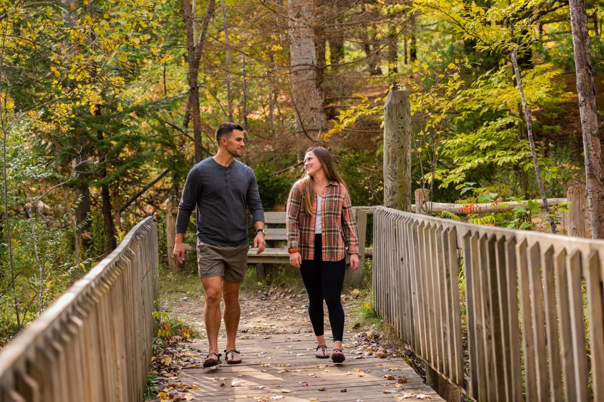 People walking along the trails behind the Grand Traverse Commons in the fall.