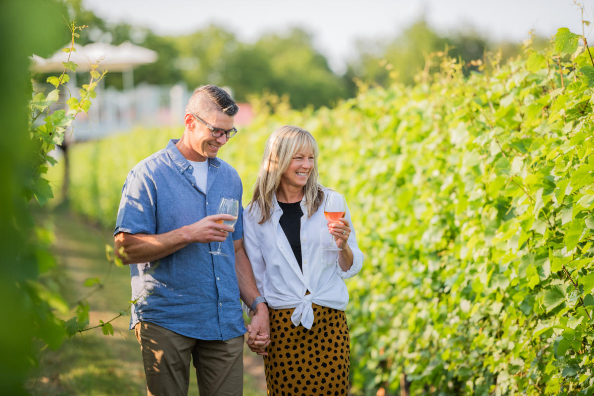 people sipping wine and walking through the vines at Brys Estate Vineyard & Winery on Old Mission Peninsula in Traverse City, Michigan