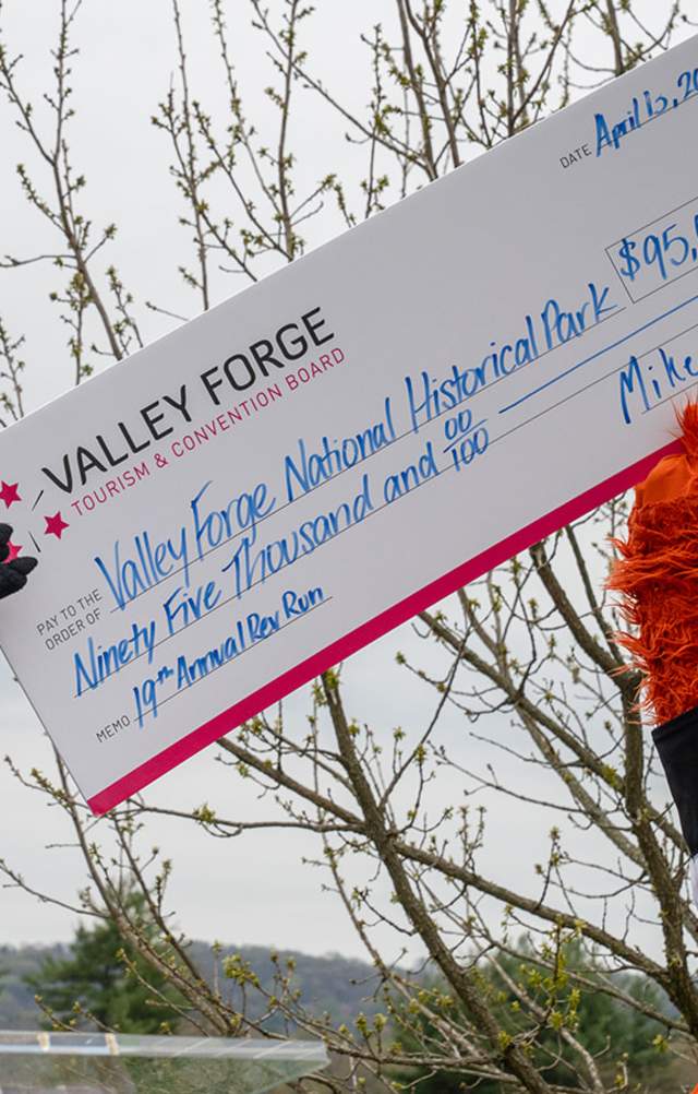 Monty and Gritty hold up the funds raised check