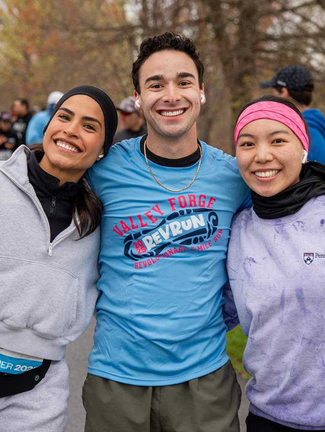 Three runners pose for a photo before the race begins