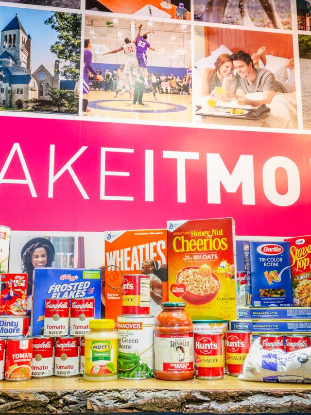 Canned goods and non-perishables are placed on a table in front of a #MakeItMontco sign