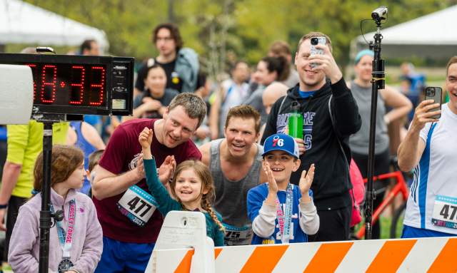 Spectator cheer on runners at the Rev Run finish line