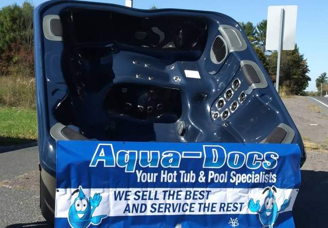 Hot tub with Aqua-Docs banner over it