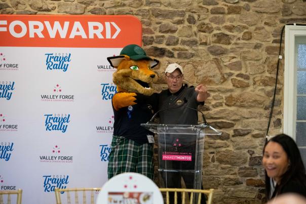 Monty the Fox poses next to Mike Bowman at the 2023 Travel Rally