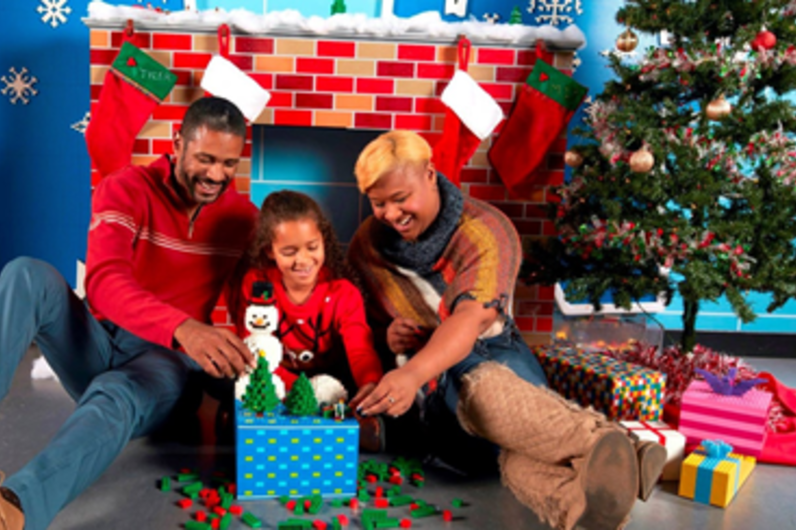 A family assembling holiday legos