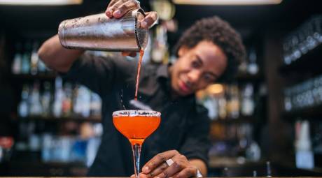 Worker pouring drink at Newbolds Food & Libations