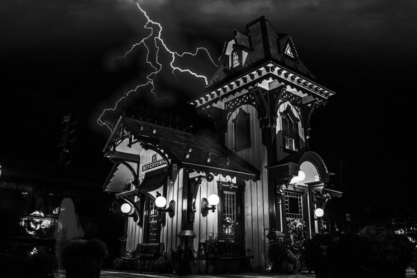 Black and white photo of the Colebrookdale Railroad station with lightning in the sky in the background