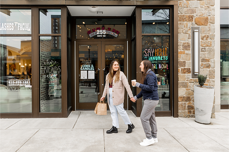 Female couple holding hands outside Cork and Candle in King of Prussia