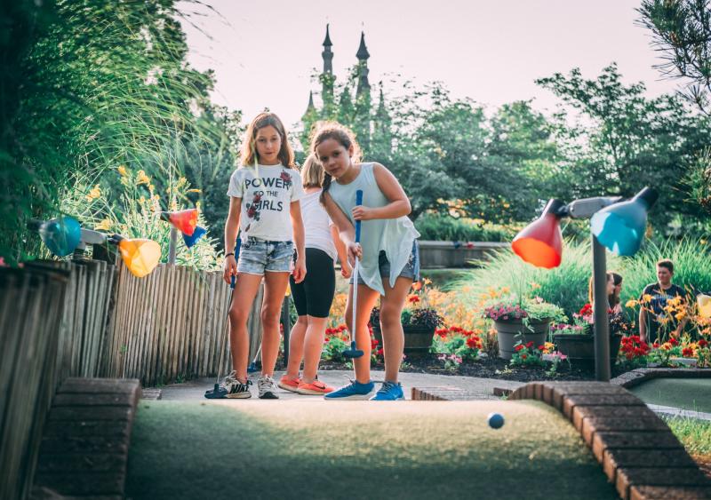 Two girls watching a ball on the mini golf course at Waltz Golf Farm