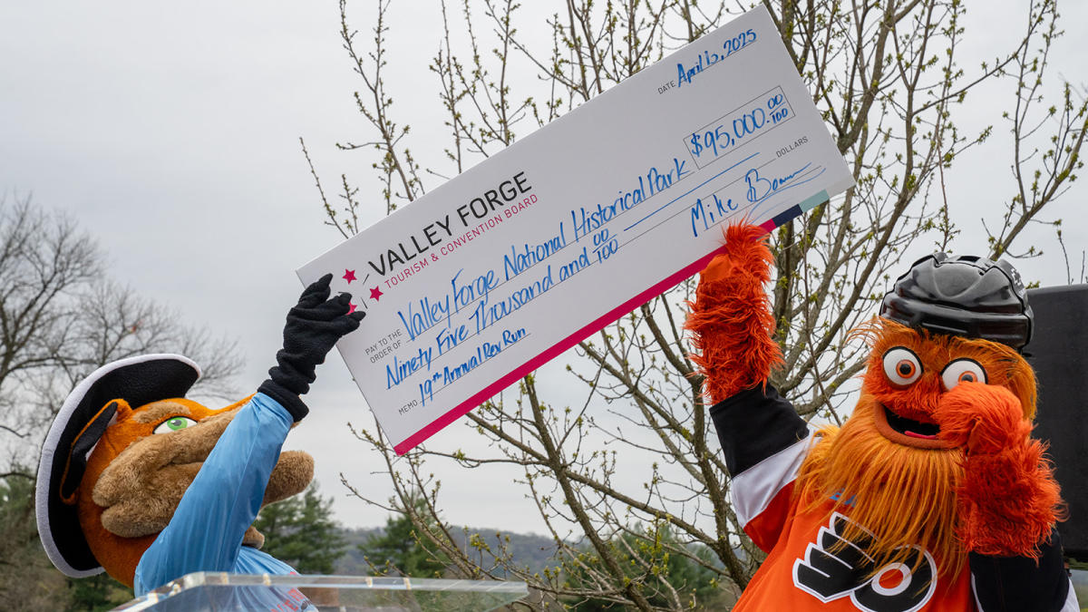 Monty and Gritty hold up the funds raised check