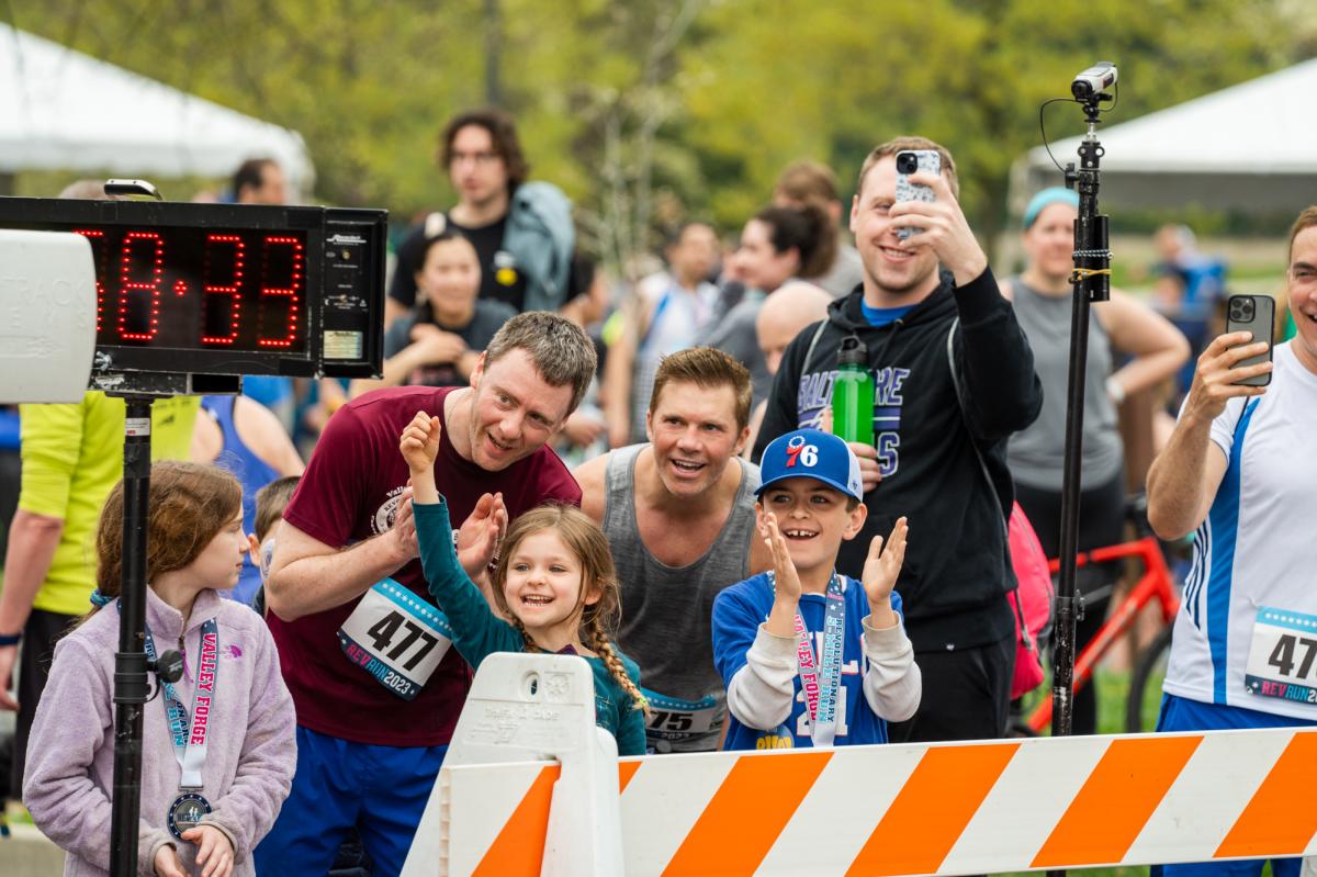 Spectator cheer on runners at the Rev Run finish line