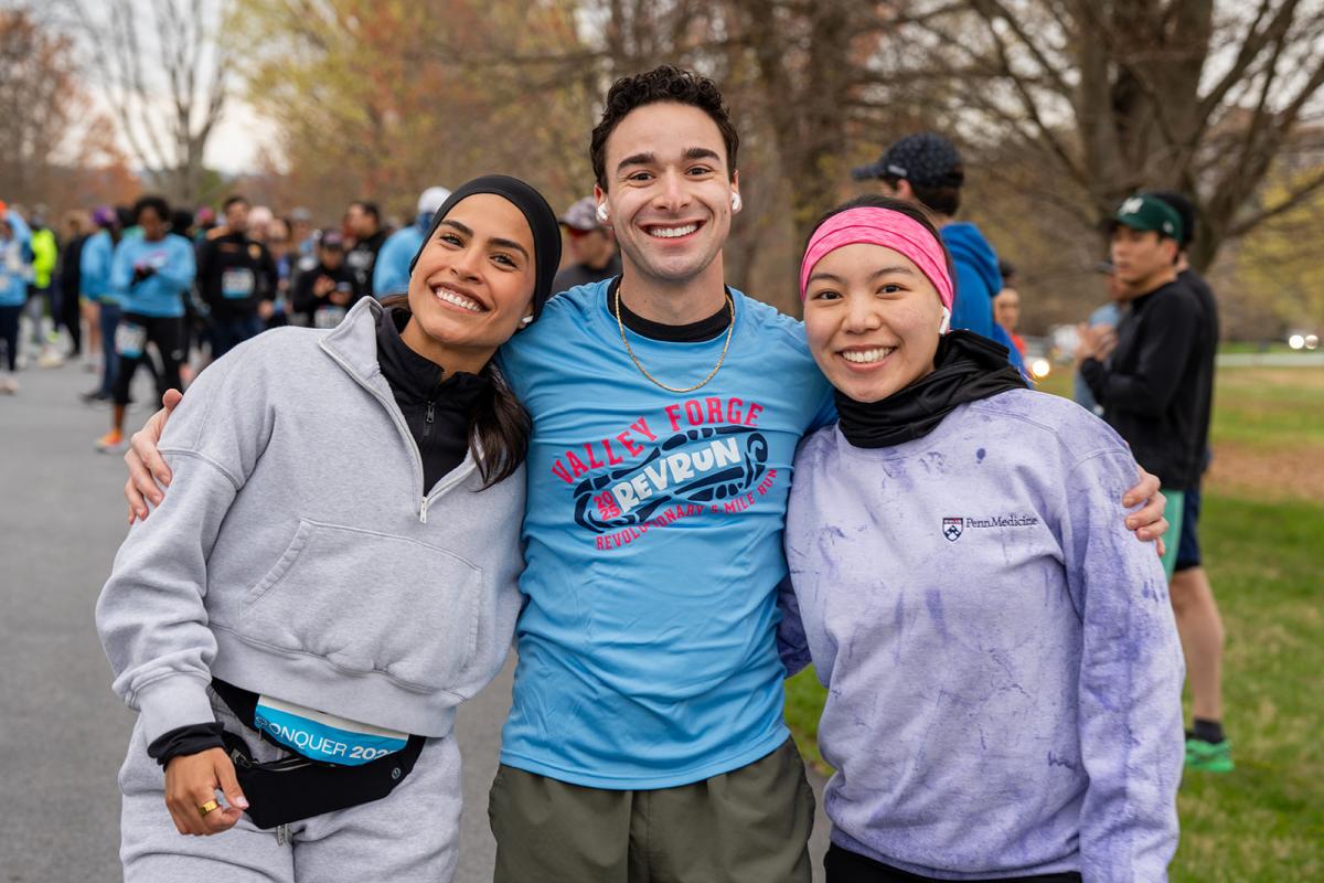 Three runners pose for a photo before the race begins