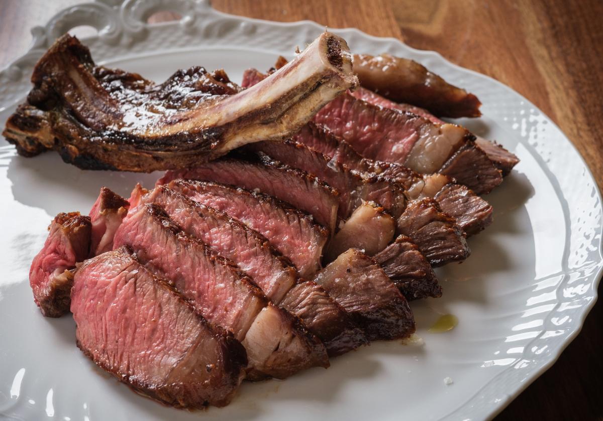 Fiore Rosso Bone-In Ribeye meal on a white plate