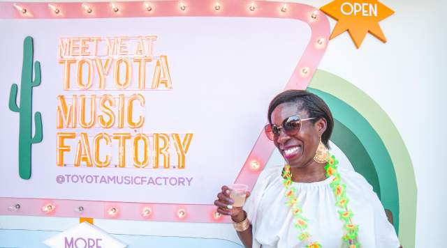 Woman in front of Meet Me at Toyota Music Factory sign