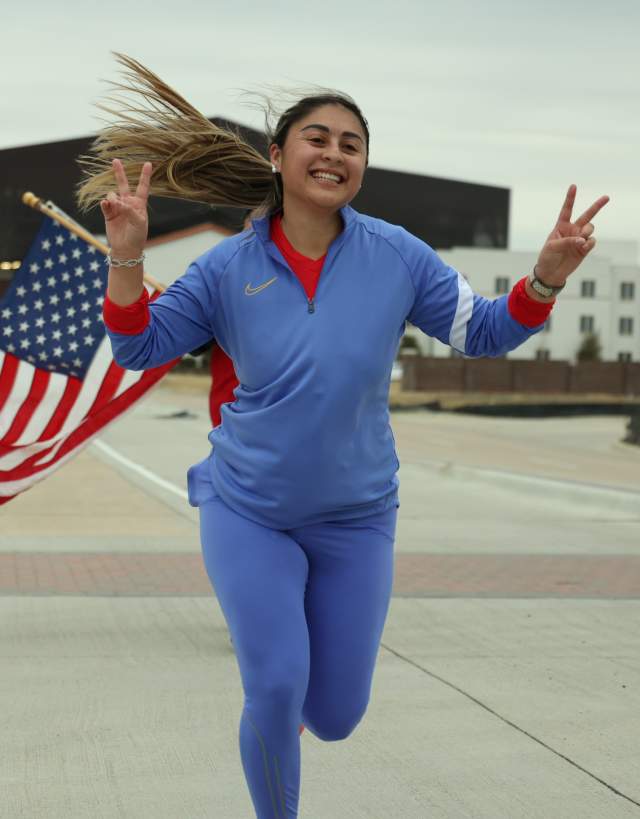 Runner with American Flag and Irving Convention Center in background