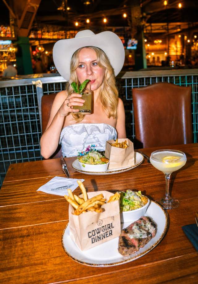 girl in cowboy hat enjoying dinner
